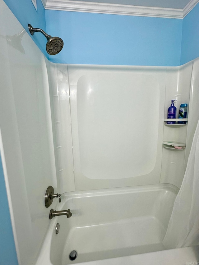 bathroom featuring ornamental molding and shower / tub combo