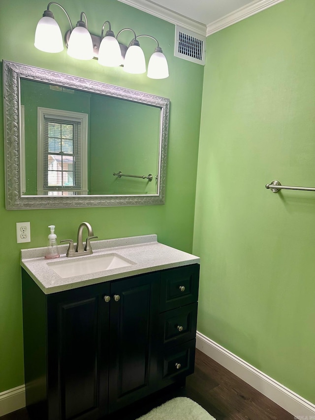 bathroom featuring vanity, crown molding, and wood-type flooring