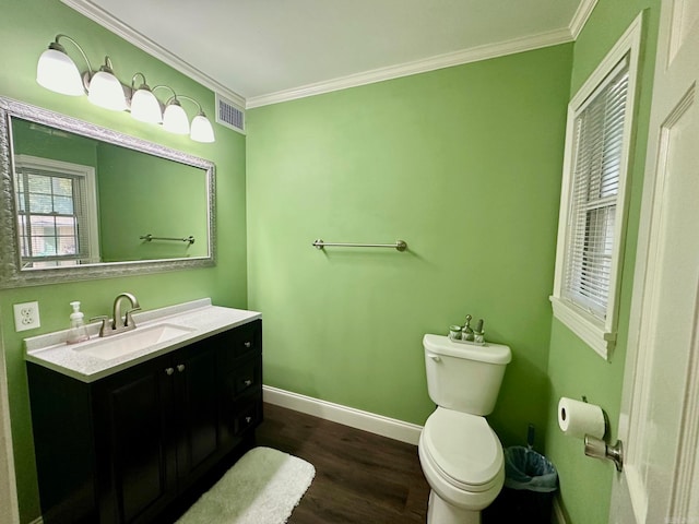 bathroom with vanity, toilet, crown molding, and wood-type flooring