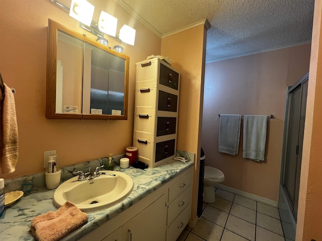 bathroom featuring tile patterned floors, toilet, crown molding, vanity, and walk in shower