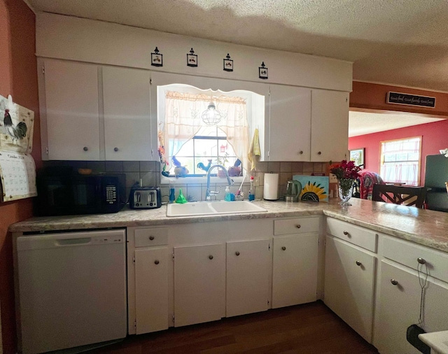 kitchen featuring white cabinetry, dishwasher, tasteful backsplash, and sink