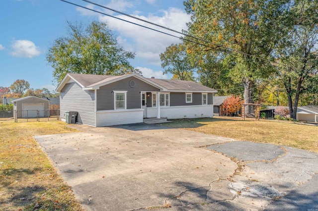 view of front of property with a front yard, a garage, and an outdoor structure