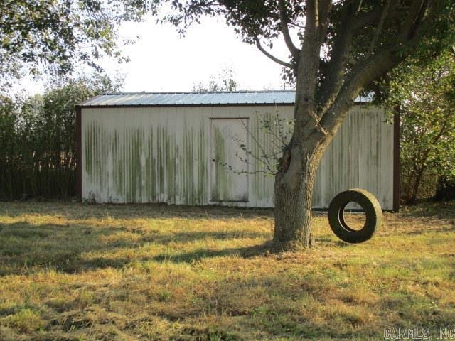 view of outbuilding with a yard