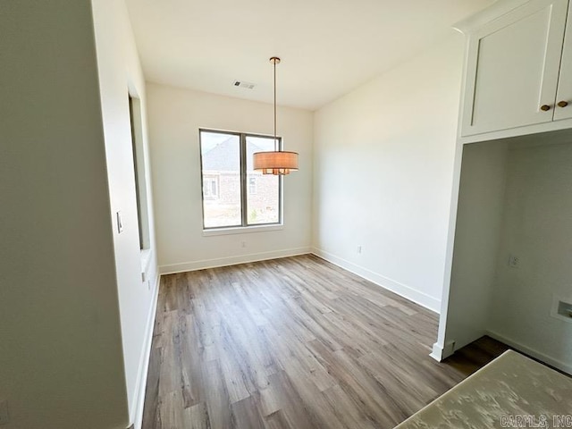 unfurnished dining area with light hardwood / wood-style flooring