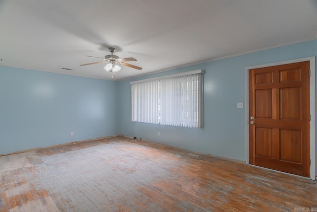 interior space with wood-type flooring, visible vents, ceiling fan, and crown molding