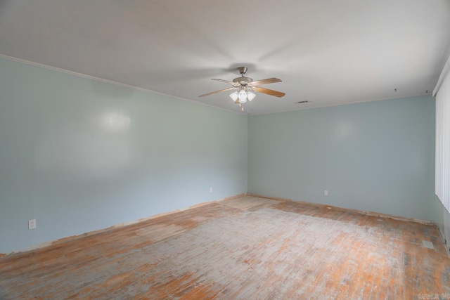 spare room with ceiling fan, light wood-type flooring, and crown molding