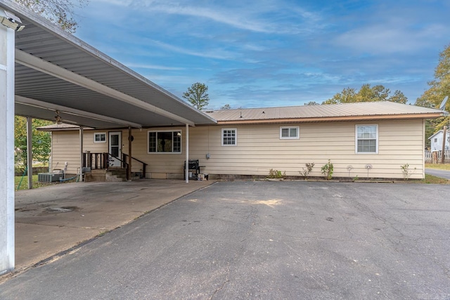 exterior space with a carport and metal roof