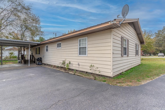 view of side of property with an attached carport