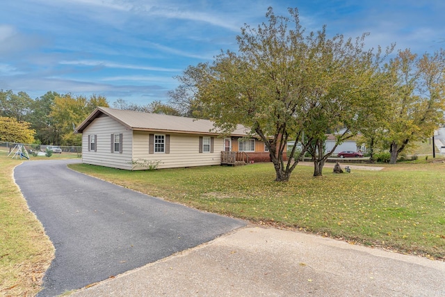 single story home with a front yard and metal roof