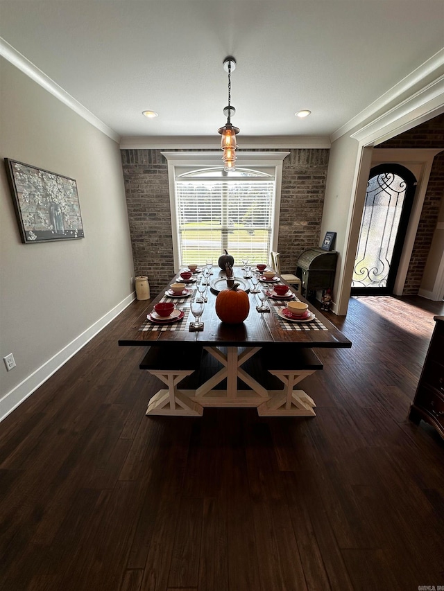 dining area featuring ornamental molding, dark wood-type flooring, and brick wall