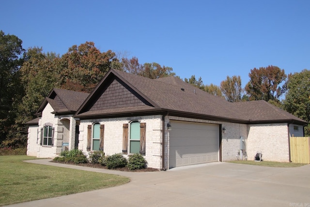 view of front of home with a front lawn and a garage