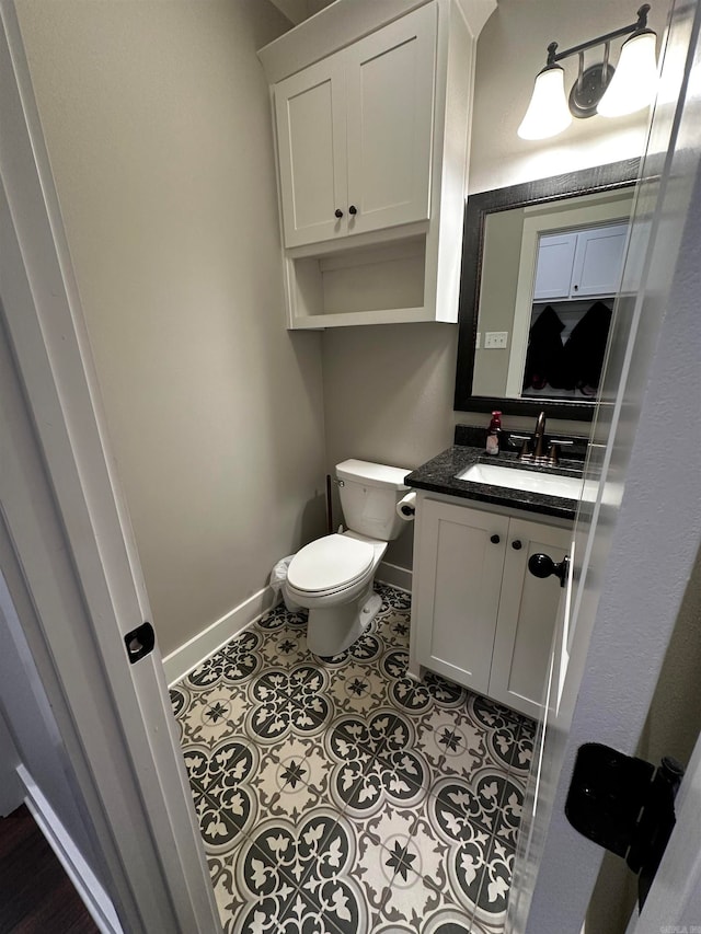 bathroom with vanity, toilet, and tile patterned flooring