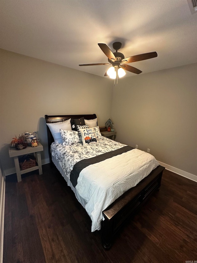 bedroom with dark wood-type flooring and ceiling fan