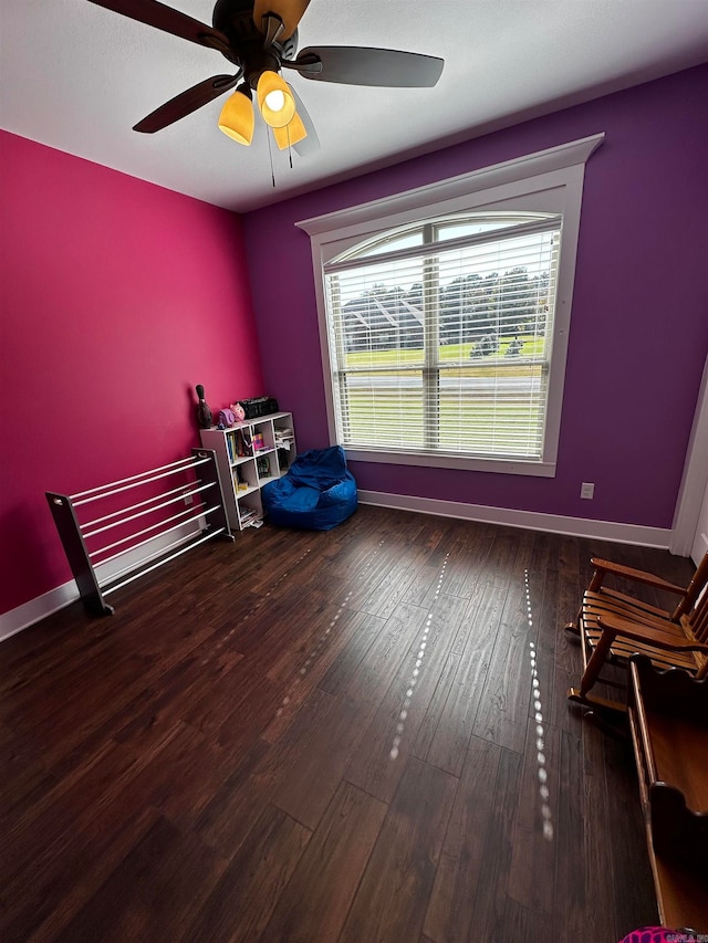 bedroom with dark hardwood / wood-style floors and ceiling fan