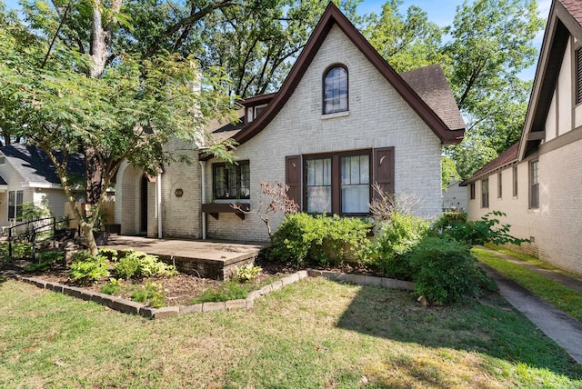 back of house featuring a lawn and a patio