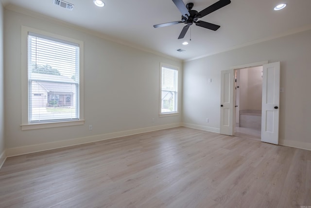 unfurnished bedroom with visible vents, light wood-type flooring, multiple windows, and crown molding