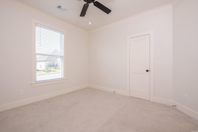 unfurnished room with ceiling fan, crown molding, visible vents, carpet, and baseboards