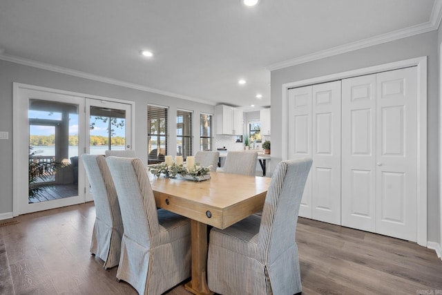 dining room featuring crown molding and light wood-type flooring