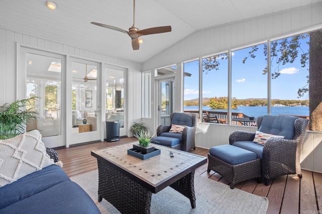 sunroom featuring a water view, ceiling fan, a healthy amount of sunlight, and vaulted ceiling