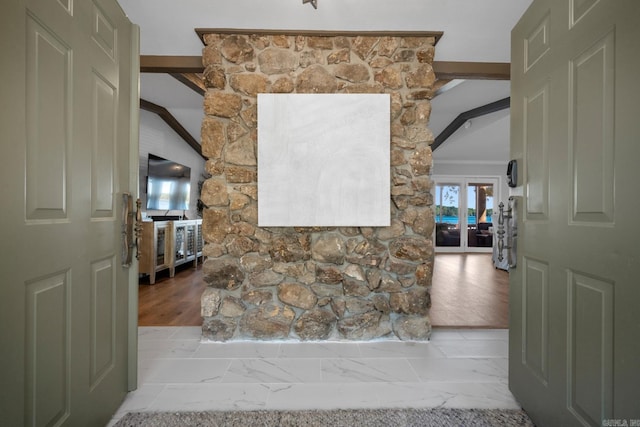 interior space with lofted ceiling with beams and light hardwood / wood-style flooring