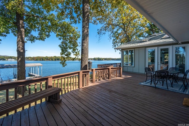 wooden terrace featuring a dock and a water view