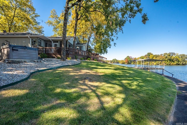 view of yard with a deck with water view and a dock