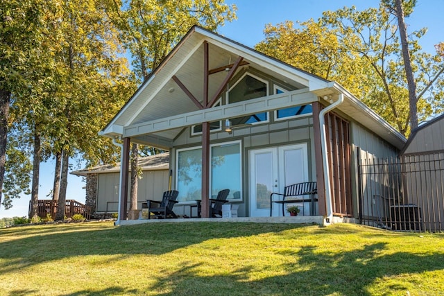 rear view of property with a yard