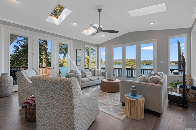 living room with french doors, dark hardwood / wood-style floors, a water view, and vaulted ceiling