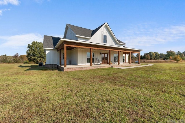 back of house featuring cooling unit, a lawn, and a porch