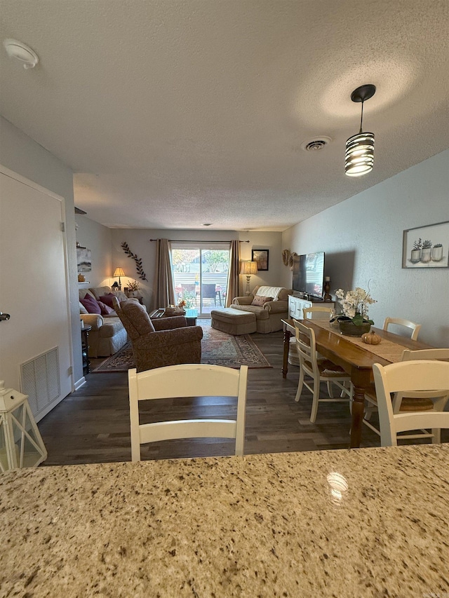 kitchen with dark wood-type flooring and a textured ceiling