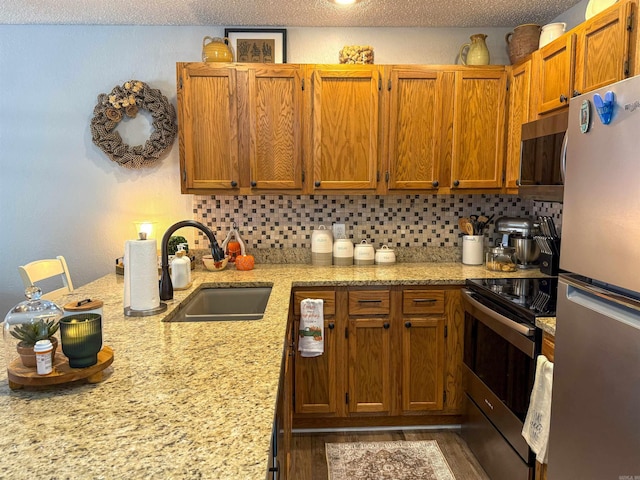 kitchen featuring dark hardwood / wood-style flooring, stainless steel appliances, sink, and backsplash