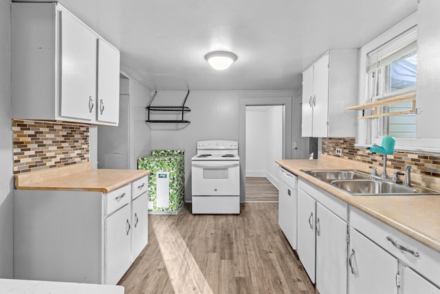 kitchen with decorative backsplash, white cabinets, light wood-type flooring, sink, and white appliances