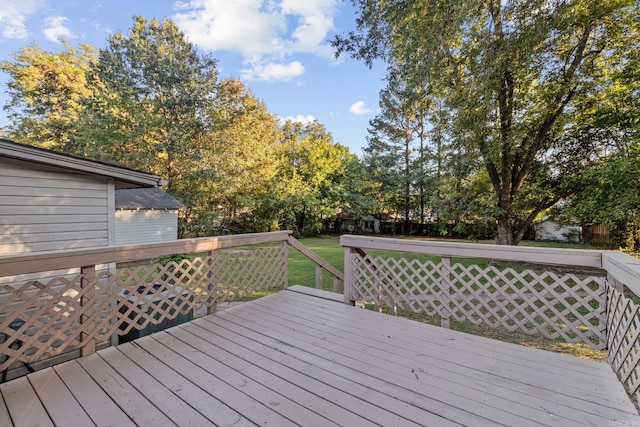 wooden terrace featuring a yard