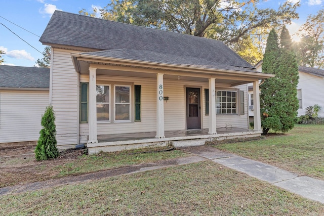 bungalow-style house featuring a porch and a front lawn