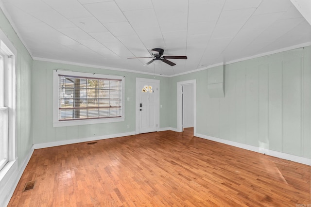 empty room with light hardwood / wood-style flooring, crown molding, and ceiling fan