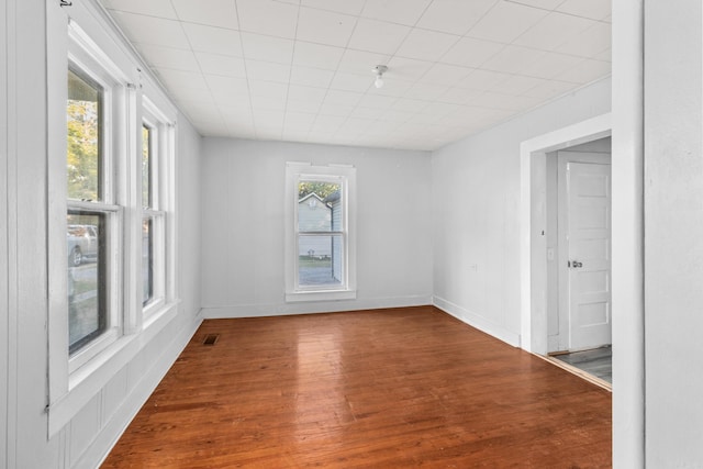 unfurnished room with hardwood / wood-style floors