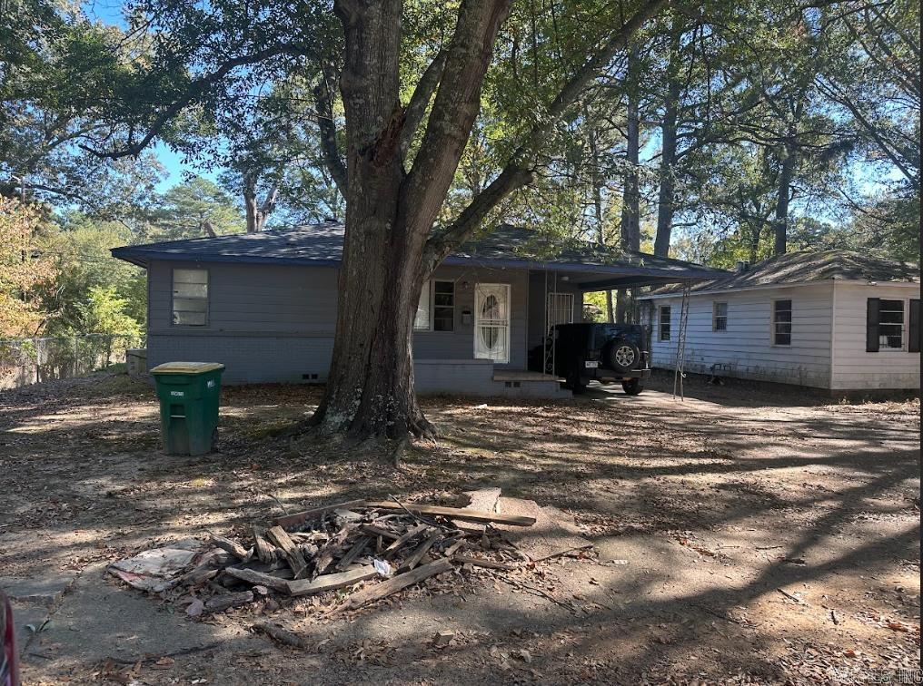 rear view of property with a carport