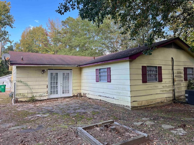 back of property featuring french doors and central AC unit