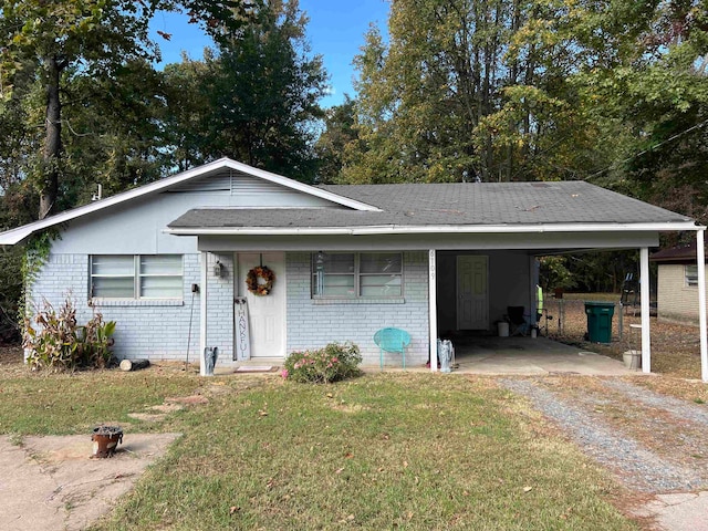 view of front facade with a front lawn and a carport