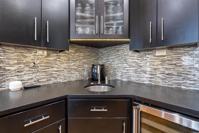 kitchen with backsplash, sink, and beverage cooler