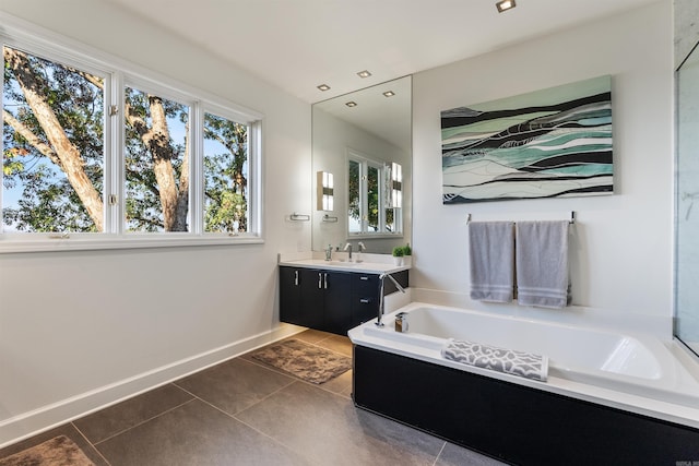 bathroom with vanity, a tub, and tile patterned floors