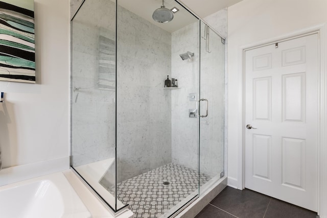 bathroom featuring plus walk in shower and tile patterned flooring