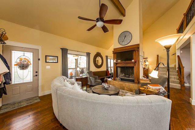 living room featuring dark wood-type flooring, ceiling fan, high vaulted ceiling, and a fireplace