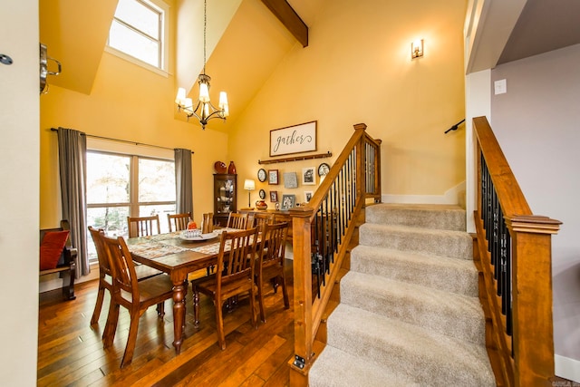 dining area featuring beamed ceiling, a chandelier, high vaulted ceiling, and dark wood-type flooring