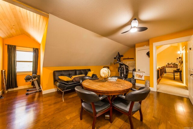 dining space with ceiling fan, wood-type flooring, and lofted ceiling