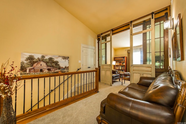 sitting room featuring lofted ceiling and light colored carpet