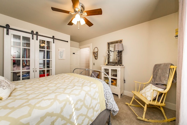 bedroom with a barn door, carpet flooring, and ceiling fan