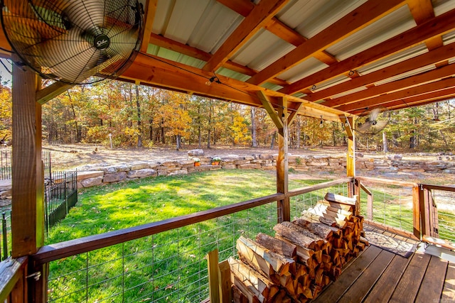 wooden terrace featuring a lawn