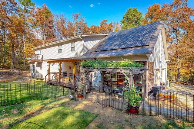 rear view of property featuring a wooden deck, cooling unit, a yard, and a patio