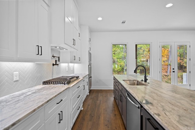 kitchen with white cabinetry, light stone countertops, sink, and dark hardwood / wood-style floors